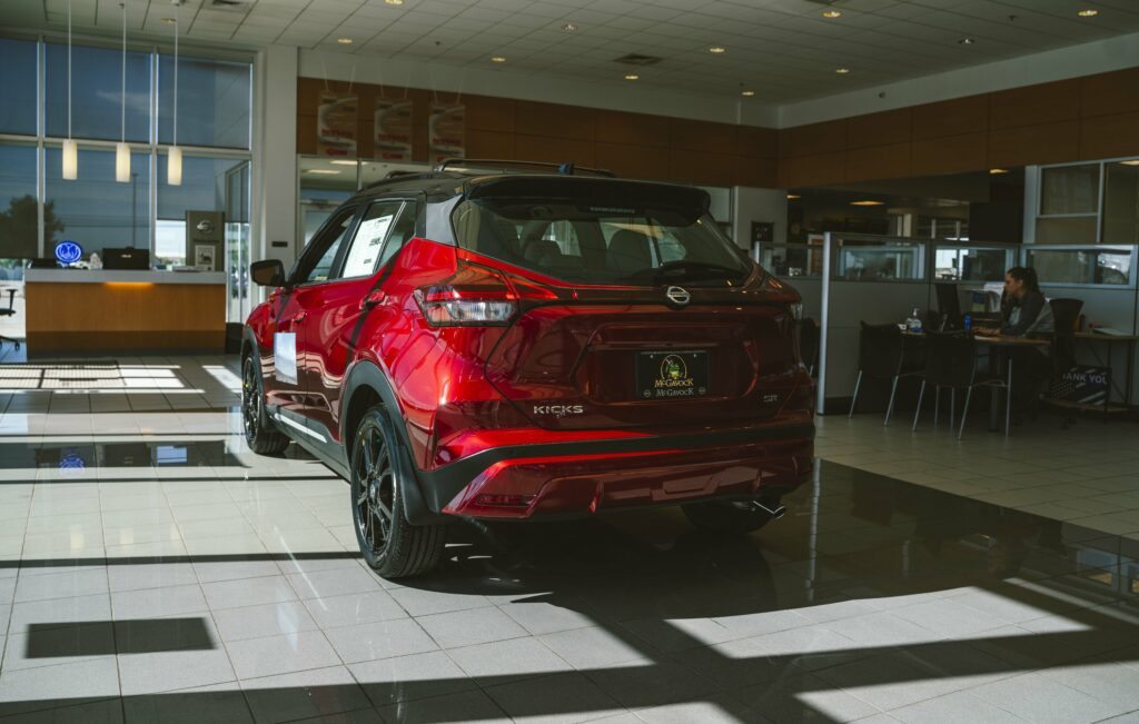 A Scarlet Ember Tintcoat 2023 Nissan Kicks at the McGavock Nissan Dealership in Lubbock.