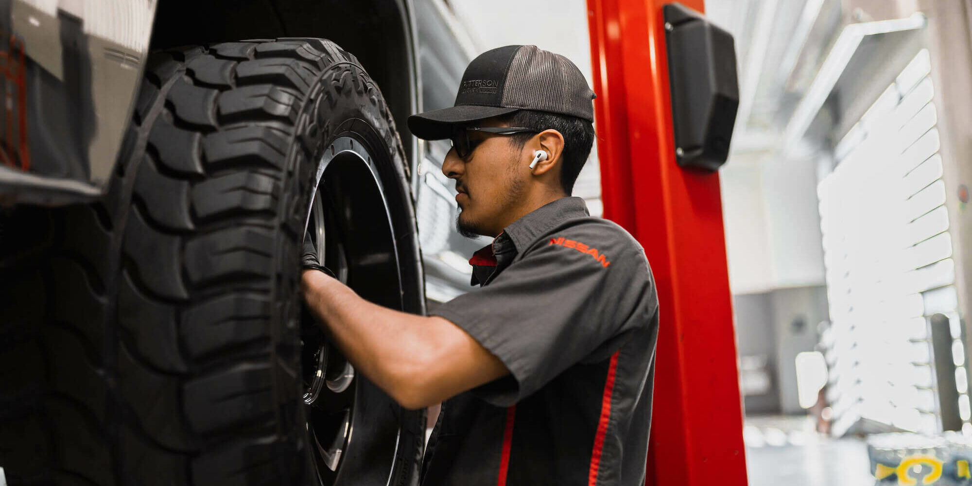 McGavock Nissan service technician checking tire